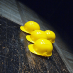 Four yellow construction hard hats on a wooden table showing the skills gap in the construction industry.
